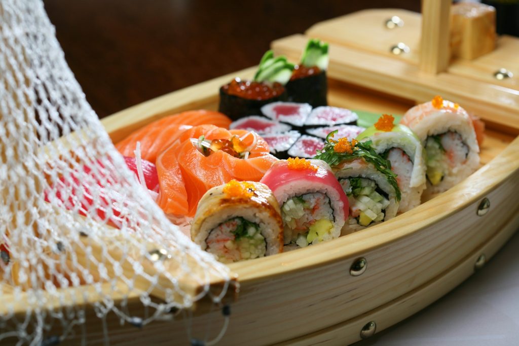 Assorted sushi served in original wooden boat.