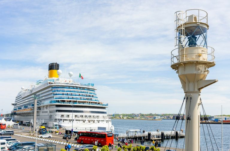 Scenic view big modern cruise liner ship docked at car tourist bus parking Oslo quay Kiel Fjord